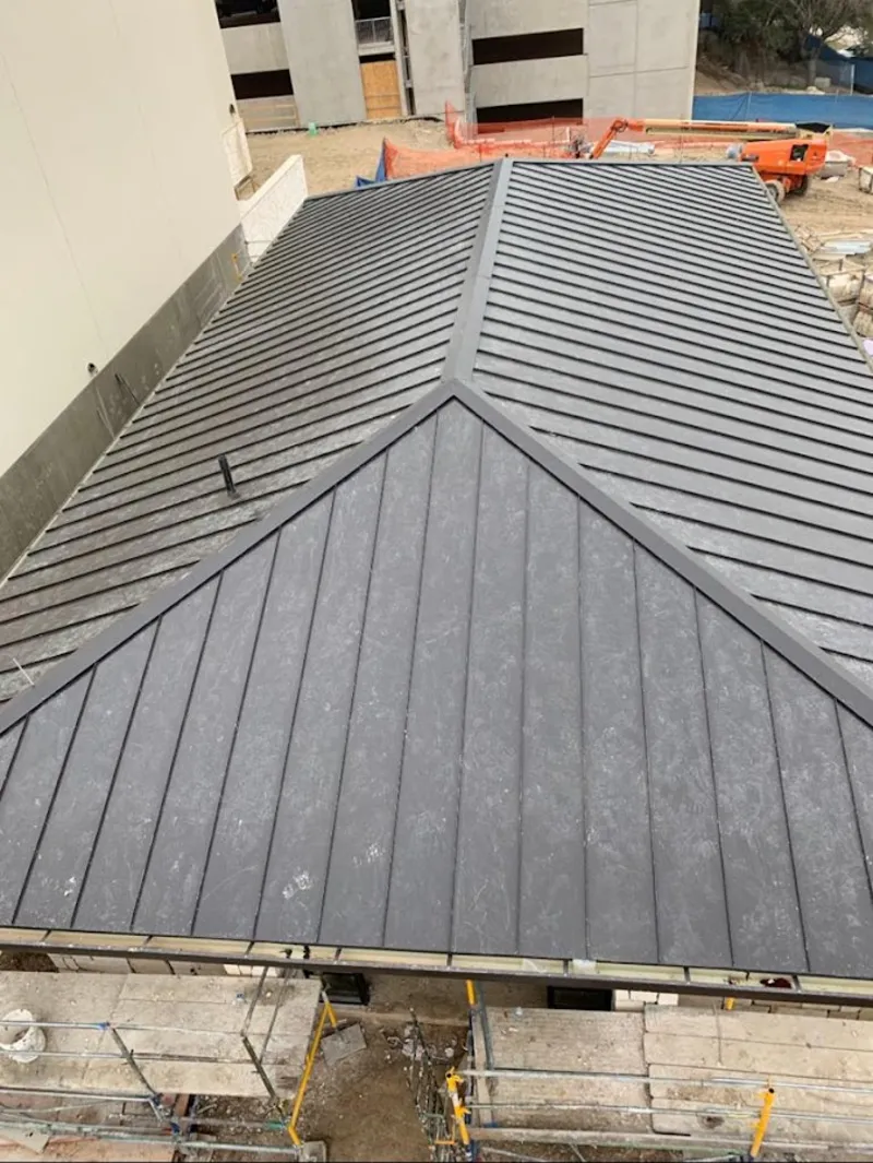 Commercial metal roof construction with crane equipment in Delphos