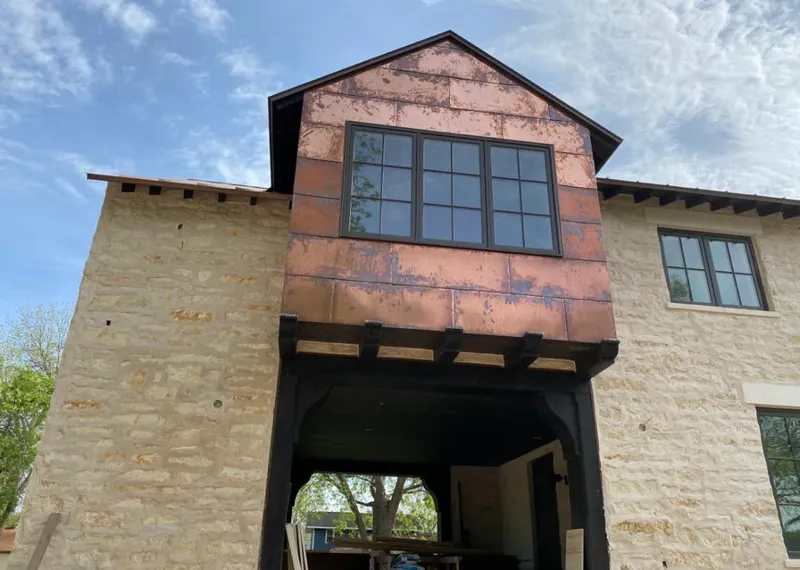Copper metal panel facade on a stone building for Metal Roof Coating in Delphos